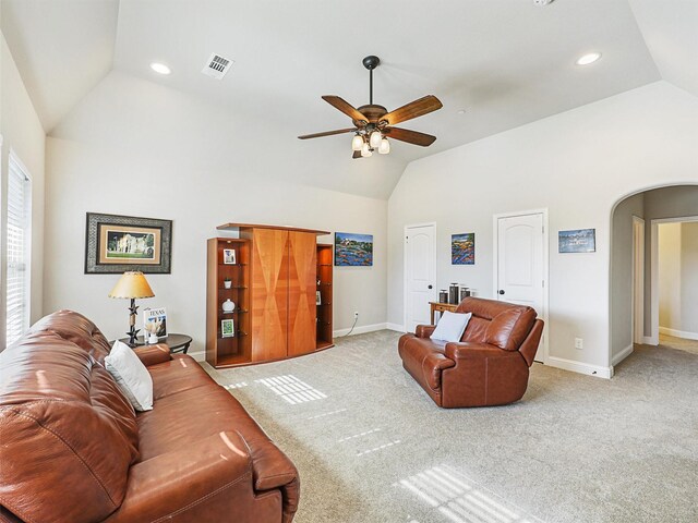 carpeted living room featuring ceiling fan and vaulted ceiling