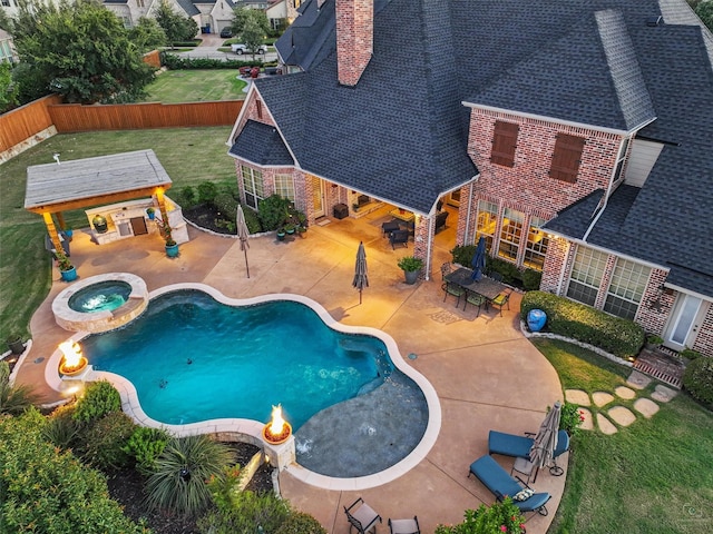 view of pool featuring an in ground hot tub, a patio area, and a lawn