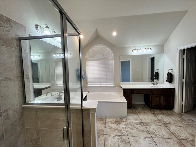 bathroom with vanity, separate shower and tub, and vaulted ceiling