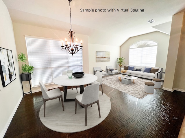 dining room with a notable chandelier, dark hardwood / wood-style floors, and vaulted ceiling