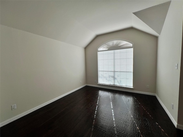 living room with a stone fireplace, dark hardwood / wood-style flooring, a healthy amount of sunlight, and lofted ceiling