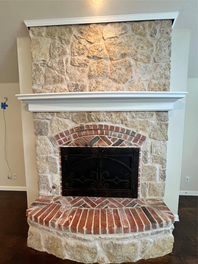 room details with a fireplace and hardwood / wood-style floors