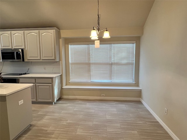 kitchen with a chandelier, decorative light fixtures, and vaulted ceiling