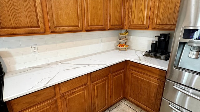 1700 Warm Springs Dr, Allen, TX 75002 - kitchen featuring tasteful backsplash, stainless steel fridge with ice dispenser, and brown cabinets