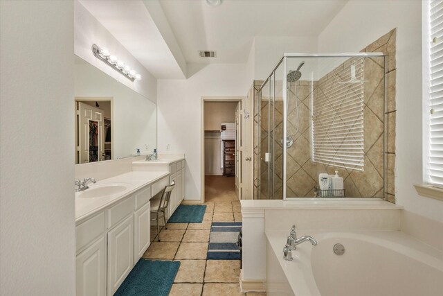 bathroom with tile patterned flooring, vanity, and independent shower and bath