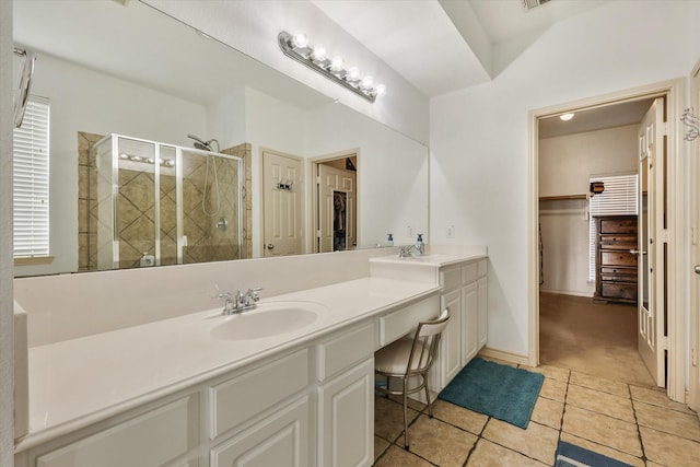 bathroom with tile patterned flooring, vanity, and a shower with shower door