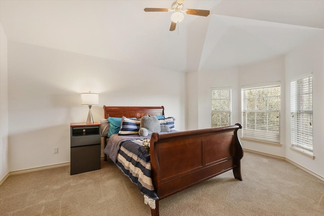 bedroom featuring ceiling fan, light colored carpet, and lofted ceiling