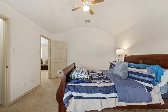 bedroom featuring light colored carpet, vaulted ceiling, and ceiling fan