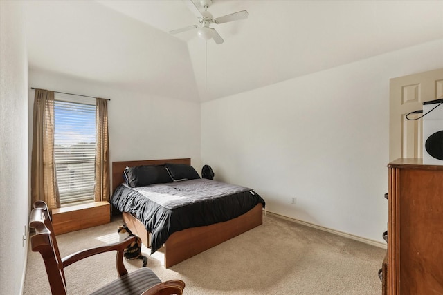 bedroom with ceiling fan, lofted ceiling, and light carpet