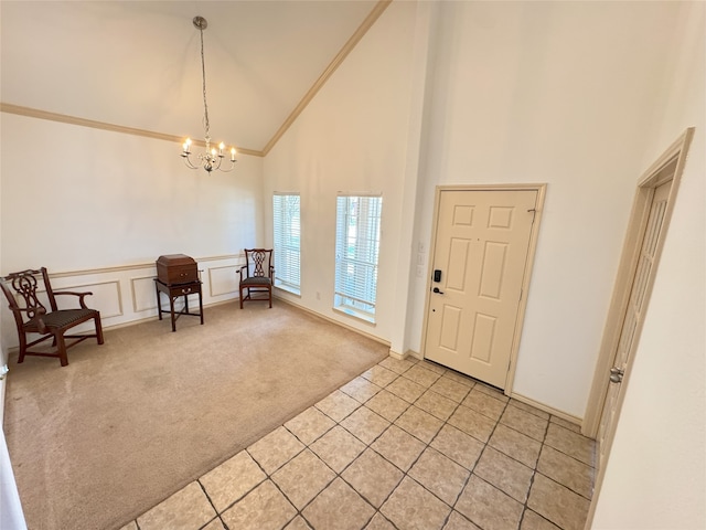 1700 Warm Springs Dr, Allen, TX 75002 - entrance foyer with light colored carpet, ornamental molding, high vaulted ceiling, an inviting chandelier, and light tile patterned floors