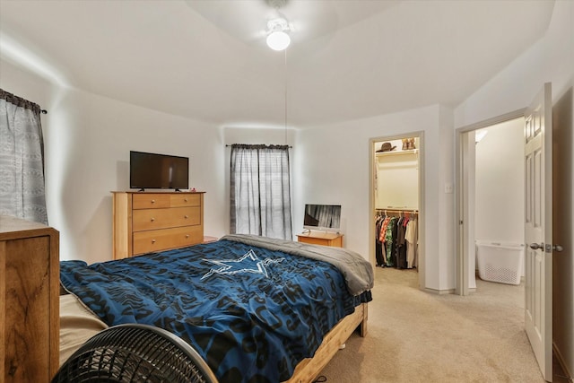 carpeted bedroom with a spacious closet and a closet