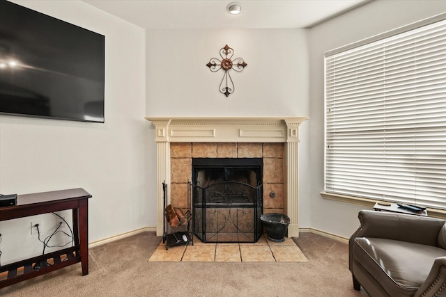 carpeted living room with a tiled fireplace