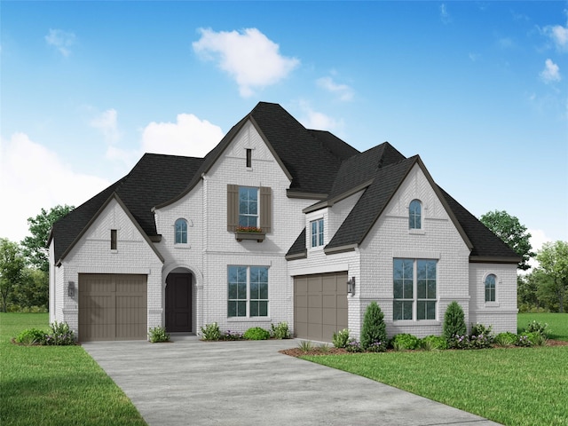 french provincial home with a garage and a front yard