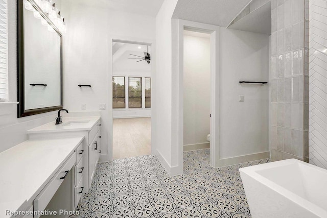 bathroom with a tub, ceiling fan, a textured ceiling, toilet, and vanity