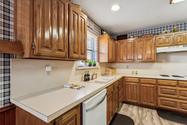 kitchen with light hardwood / wood-style floors, white appliances, and sink