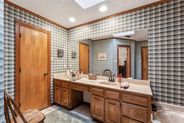 bathroom featuring vanity, tile patterned floors, a bathing tub, ornamental molding, and a textured ceiling