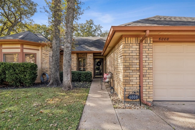 view of front of property with a front lawn and a garage