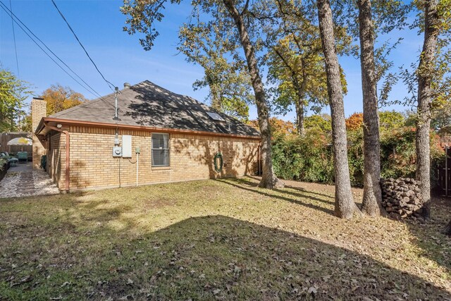 back of house with a lawn