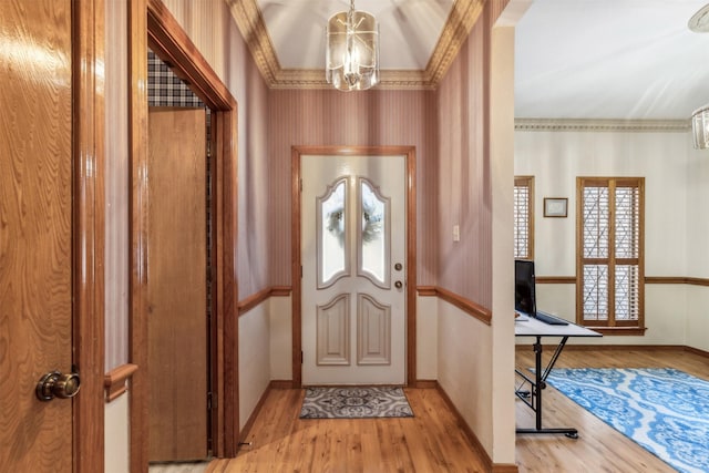 entrance foyer featuring light hardwood / wood-style floors, an inviting chandelier, and a healthy amount of sunlight