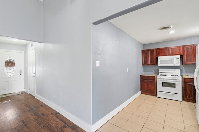 kitchen featuring light hardwood / wood-style flooring and white appliances