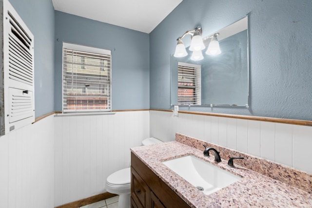 bathroom featuring tile patterned flooring, vanity, and toilet