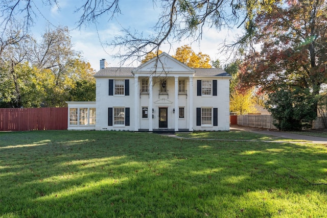 greek revival house with a front lawn