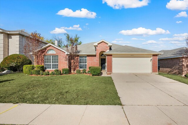 ranch-style house with a garage and a front lawn