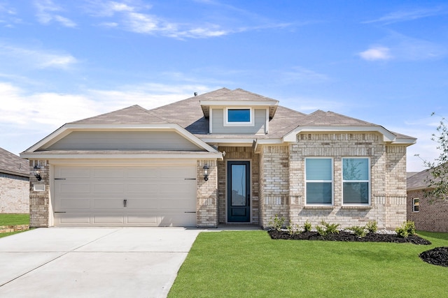 view of front of property with a front yard and a garage