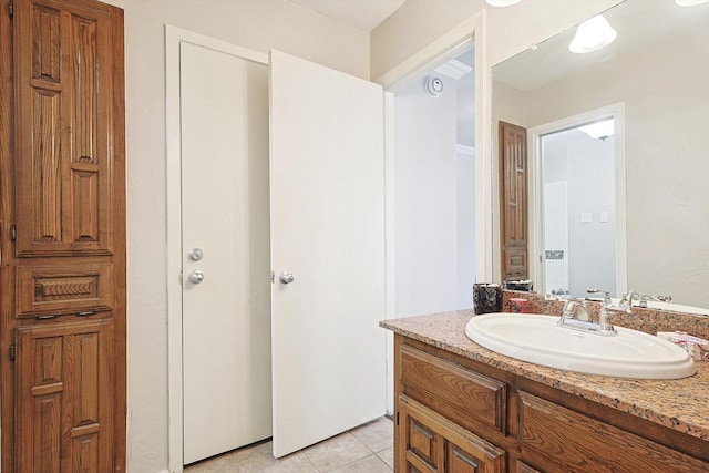 bathroom featuring tile patterned flooring and vanity