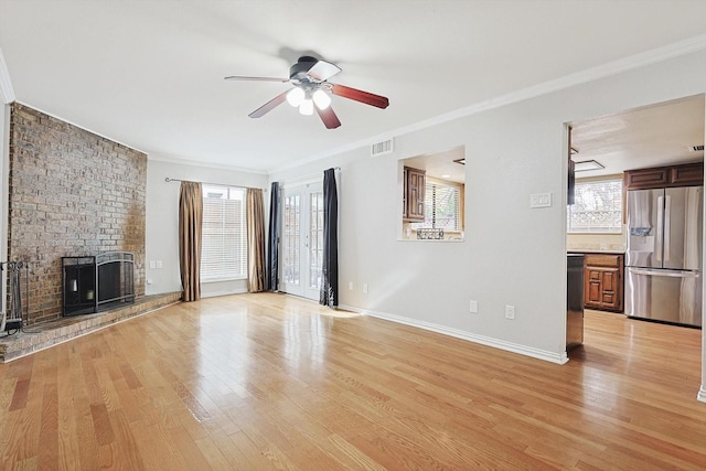 unfurnished living room featuring ceiling fan, light wood-type flooring, and ornamental molding