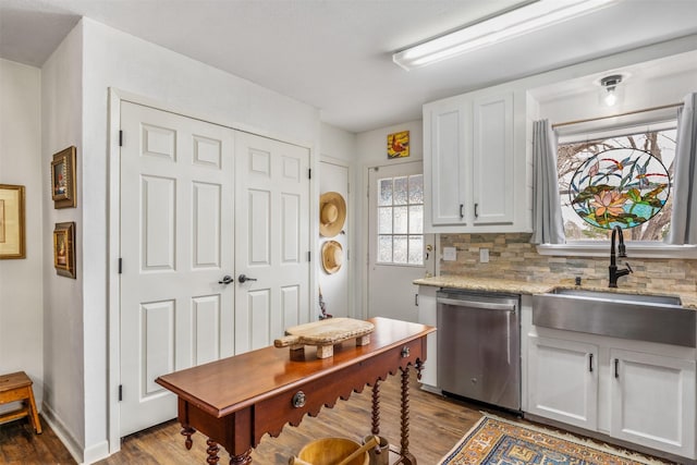 kitchen with dishwasher, white cabinets, sink, dark hardwood / wood-style floors, and tasteful backsplash