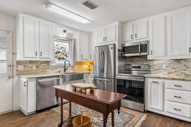 kitchen featuring white cabinetry, stainless steel appliances, and dark wood-type flooring