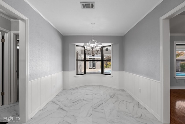 dining space with a notable chandelier and crown molding