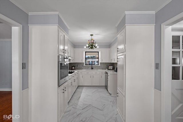 kitchen with white cabinetry, stainless steel appliances, sink, and backsplash