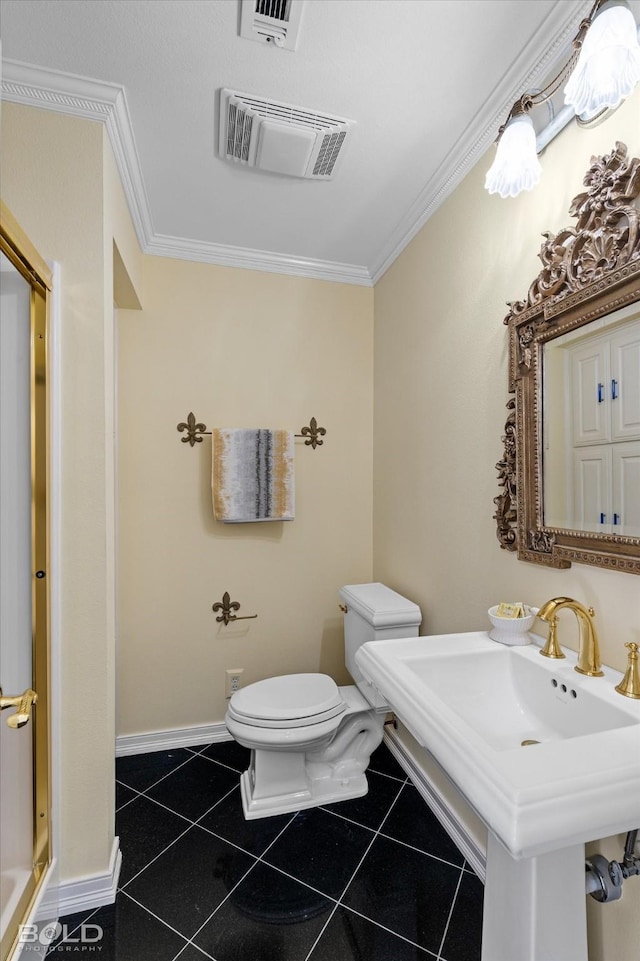 bathroom with crown molding, tile patterned floors, and toilet