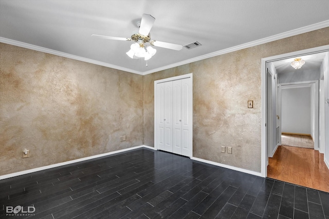 unfurnished bedroom with crown molding, dark wood-type flooring, a closet, and ceiling fan