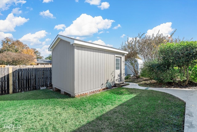 view of outdoor structure featuring a lawn