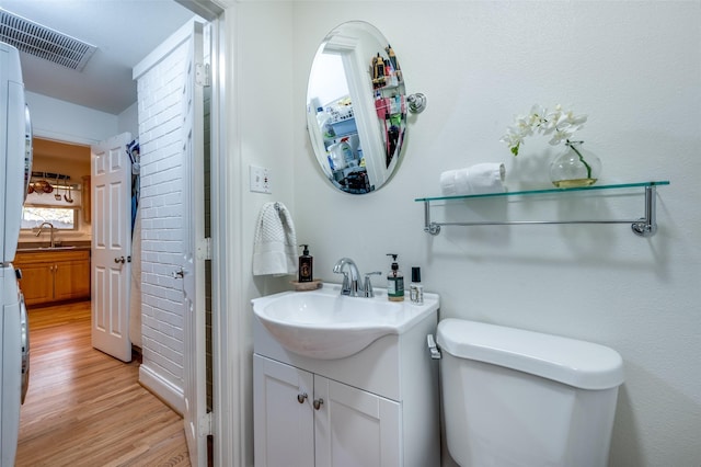 bathroom with vanity, toilet, and wood-type flooring