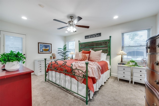 carpeted bedroom with multiple windows and ceiling fan