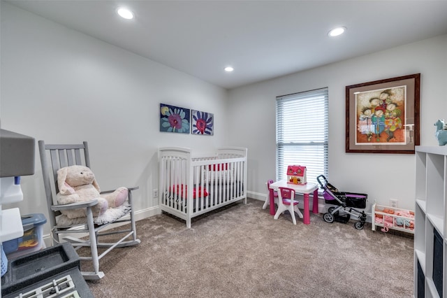 bedroom featuring light carpet and a nursery area