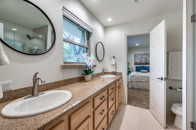 bathroom featuring tile patterned flooring, vanity, and toilet