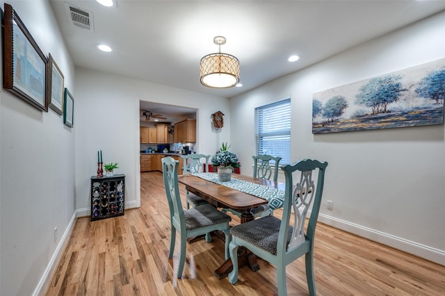 dining area with ceiling fan and light wood-type flooring