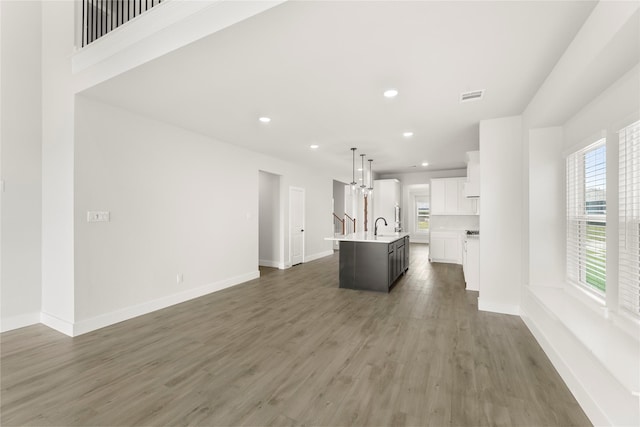 1514 Overton St, Frisco, TX 75036 - kitchen featuring healthy amount of natural light, light countertops, an island with sink, open floor plan, and recessed lighting