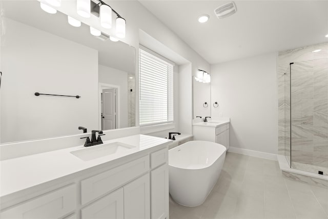 1514 Overton St, Frisco, TX 75036 - full bath featuring a shower stall, two vanities, a freestanding tub, tile patterned floors, and recessed lighting