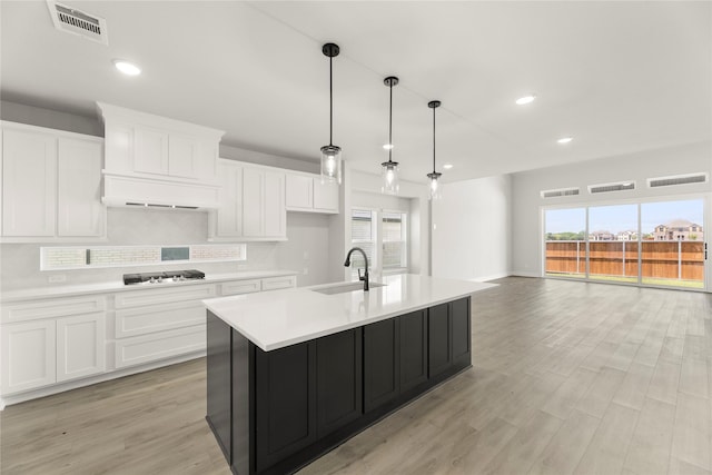 1514 Overton St, Frisco, TX 75036 - kitchen featuring a sink, light countertops, white cabinets, and recessed lighting