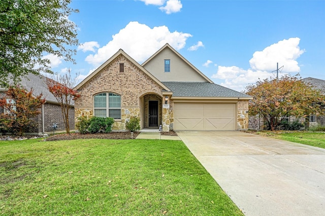 view of front of property with a garage and a front yard