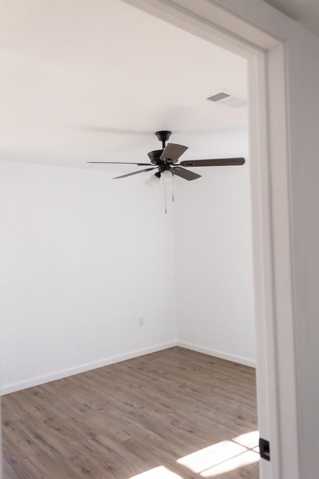 unfurnished room featuring light wood-type flooring and ceiling fan