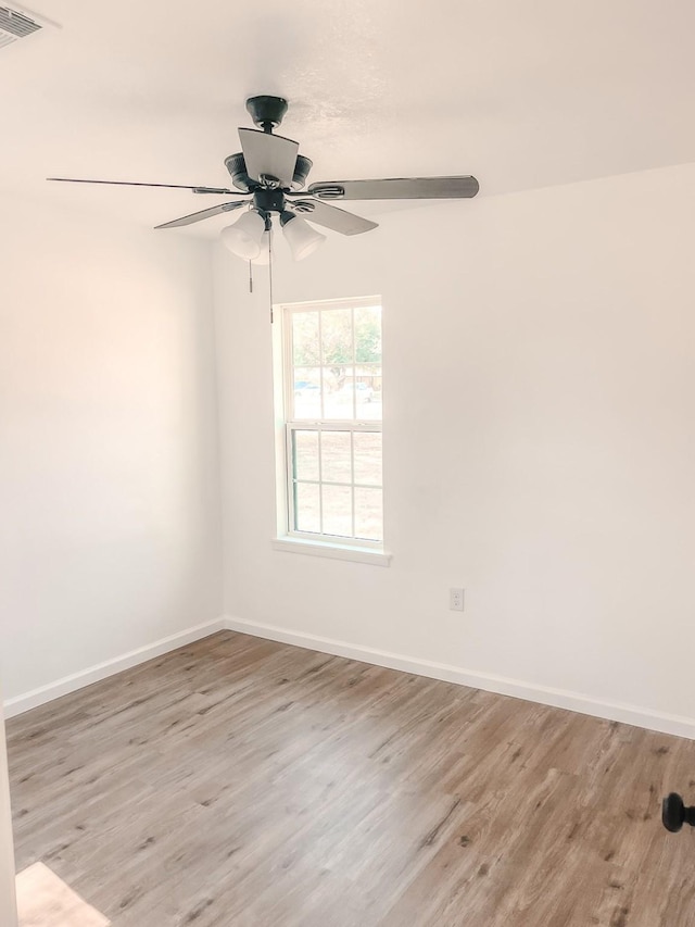 empty room with ceiling fan and light wood-type flooring