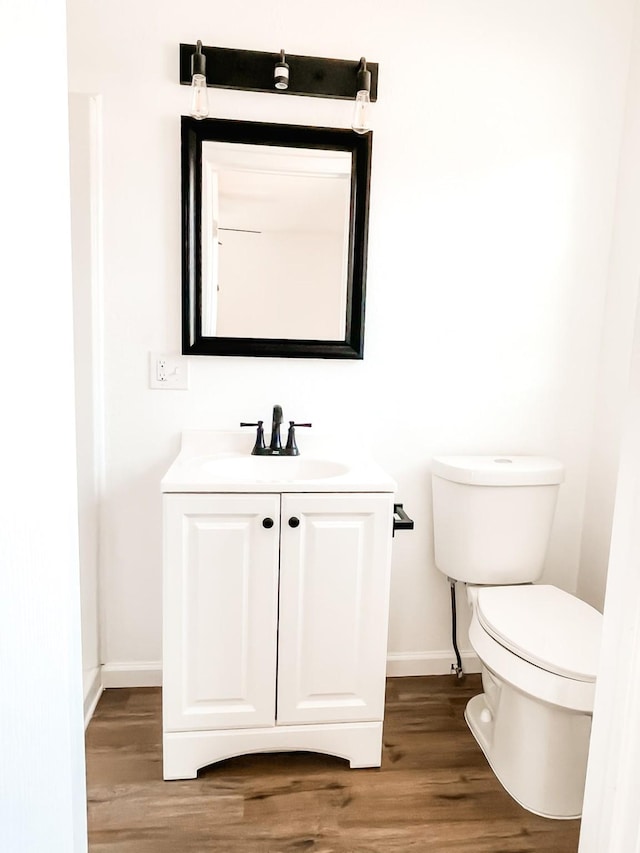 bathroom featuring hardwood / wood-style floors, vanity, and toilet