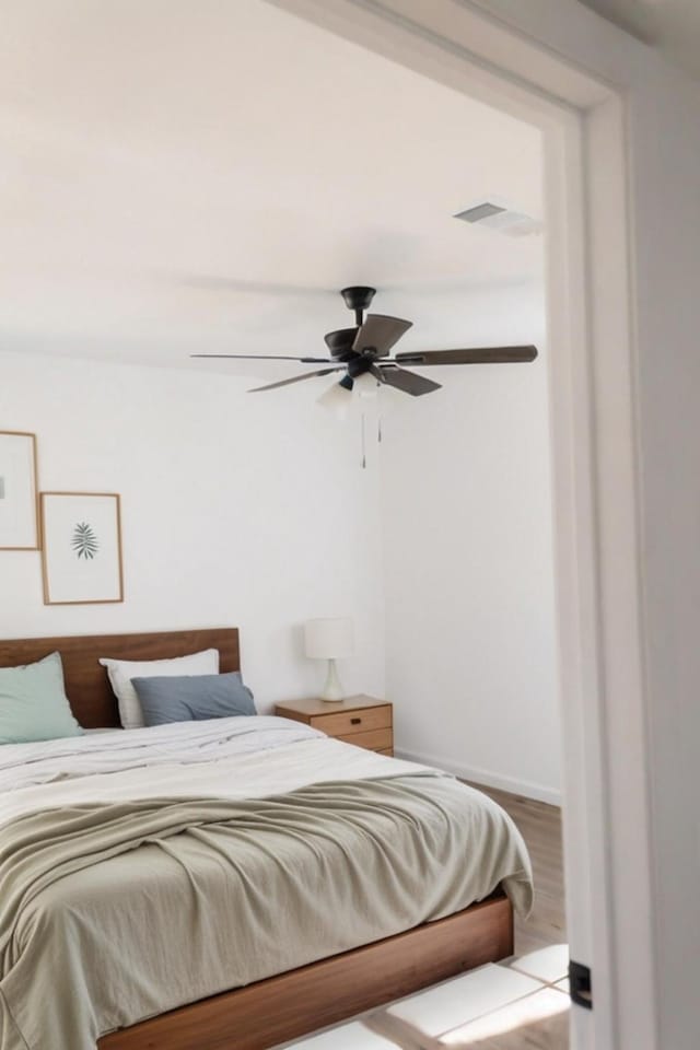 bedroom featuring wood-type flooring and ceiling fan